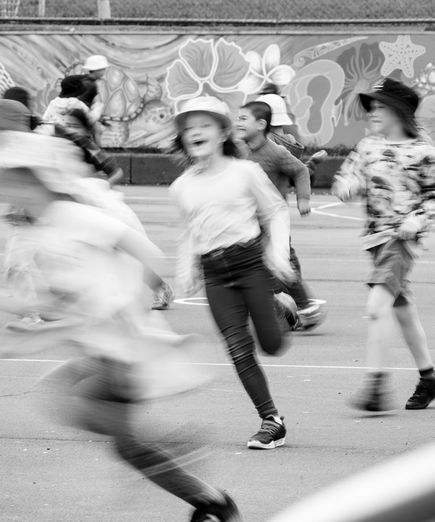 Children running around a courtyard.